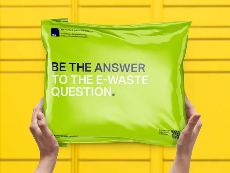 Hands hold a shiny green package reading "Be the answer to the e-waste question" against a bright yellow background. Hands hold a shiny green package reading "Be the answer to the e-waste question" against a bright yellow background.